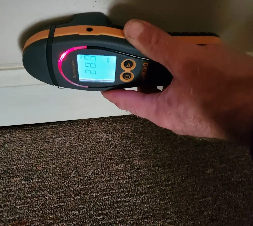 Moisture detection at baseboard during Storm Damage Restoration in Ojus